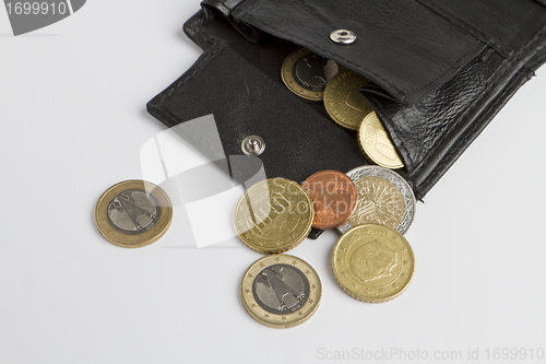 Image of loose cash falling out of black wallet