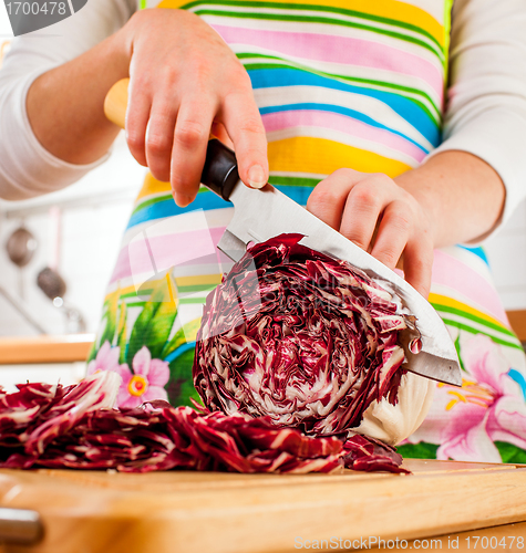 Image of Woman's hands cutting red cabbage