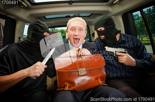 Image of businessman grasped in hostages.