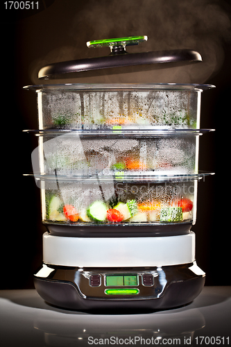 Image of Healthy cooking, steam cooker with vegetables