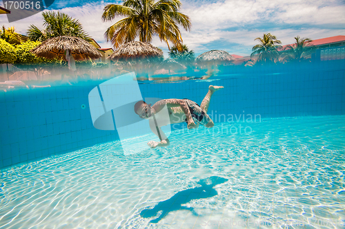 Image of teenager floats in pool