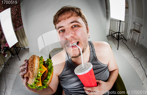 Image of fat man eating hamburger