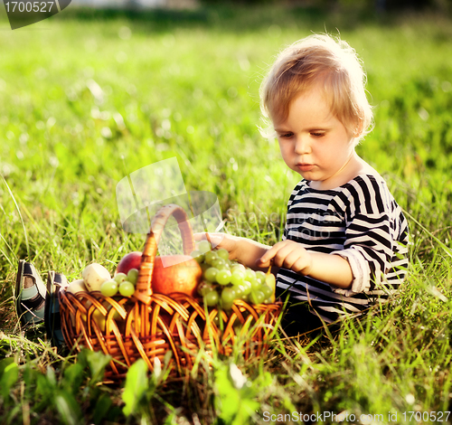 Image of little boy with a basket of fruit