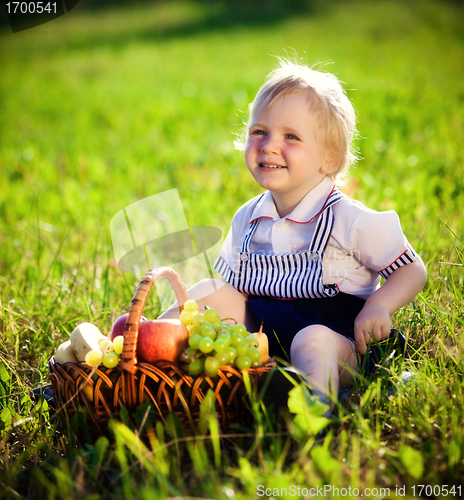 Image of little boy with a basket of fruit