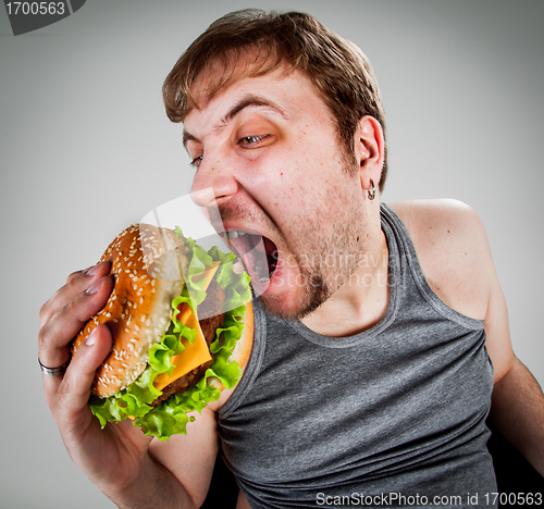 Image of fat man eating hamburger