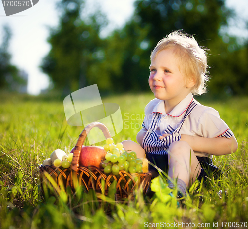 Image of little boy with a basket of fruit