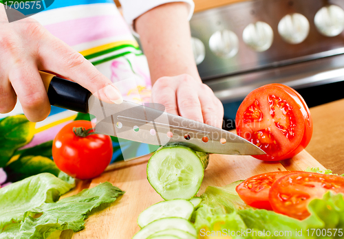 Image of Woman's hands cutting vegetables