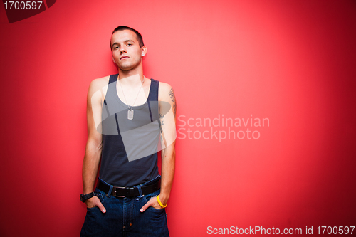 Image of Young handsome man on red wall