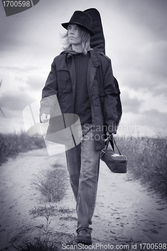 Image of Young musician walking on the field