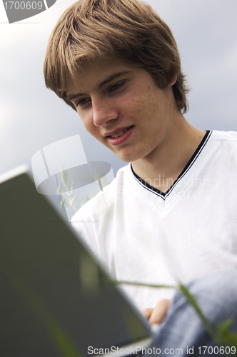 Image of Boy with notebook on the field