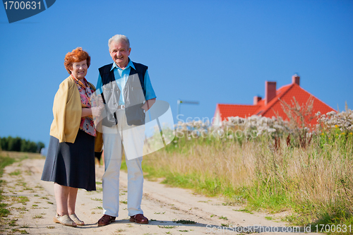 Image of Happy senior couple and house