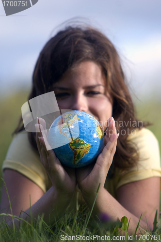 Image of Pretty girl watching earth globe