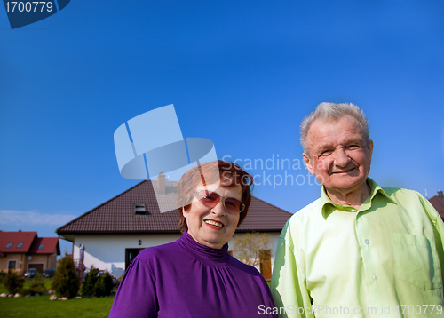 Image of Senior couple in front of the house