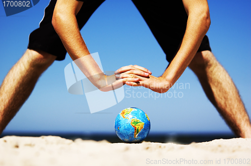 Image of Earth globe with hands over it. Conceptual image