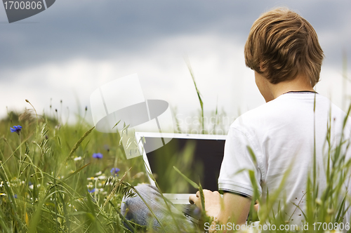 Image of Boy with notebook on the field