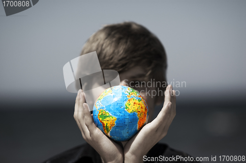 Image of Earth globe in hands. Conceptual image