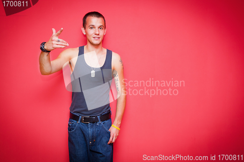 Image of Young handsome man on red wall