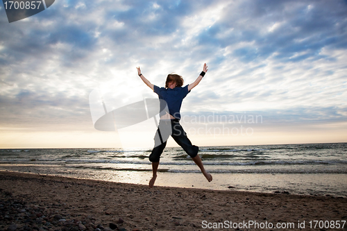 Image of Happy young man jumping