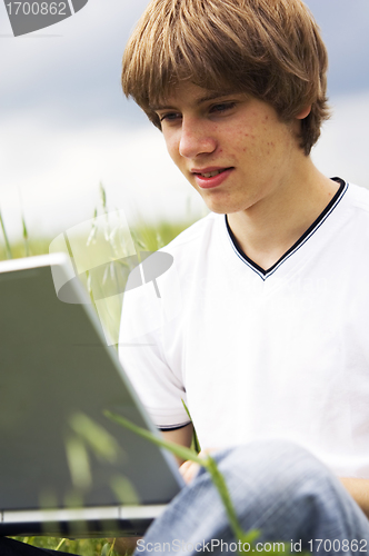 Image of Boy with notebook on the field