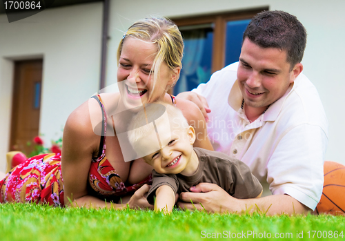 Image of Happy family in front of the house