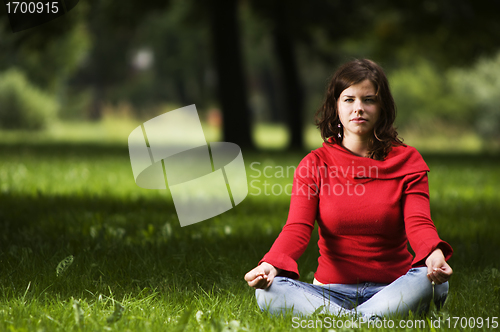 Image of Young woman doing yoga