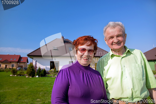 Image of Senior couple in front of the house