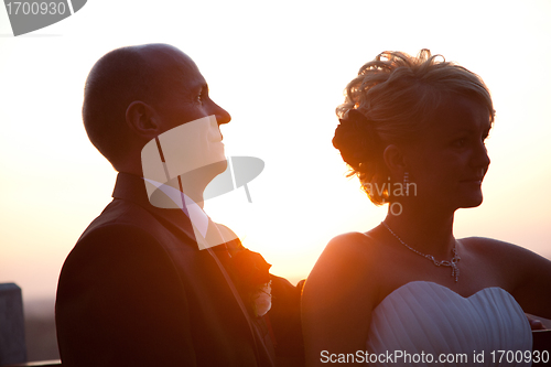 Image of Bride and groom portrait at sunset
