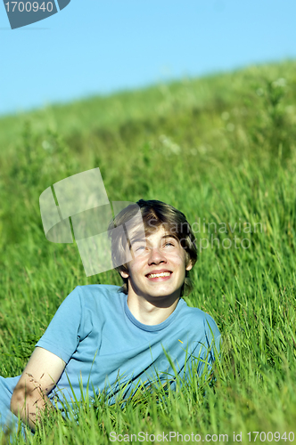 Image of Boy lying on the fresh green grass