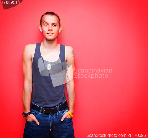 Image of Young handsome man on red wall