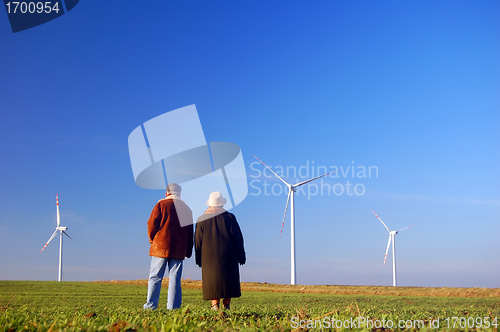 Image of Seniors' couple and wind turbines