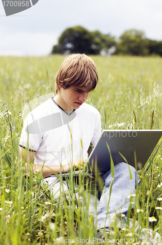 Image of Boy with notebook on the field