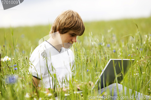 Image of Boy with notebook on the field