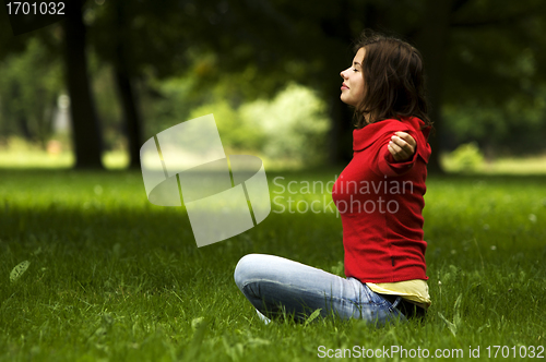 Image of Young woman doing yoga