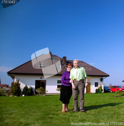 Image of Senior couple in front of the house