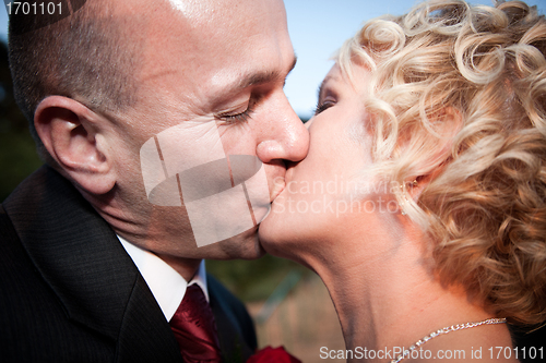 Image of Happy bride and groom kissing