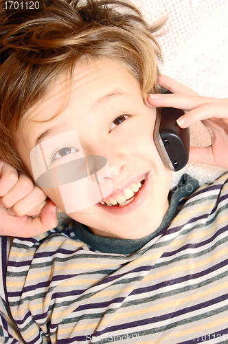 Image of Teen boy talking on cell phone