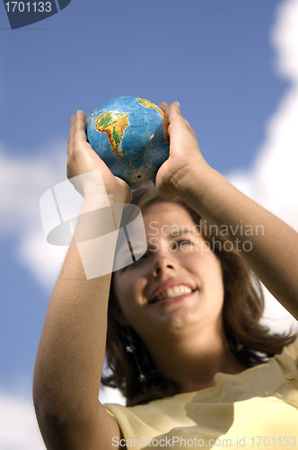 Image of Pretty girl watching earth globe