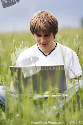 Image of Boy with notebook on the field