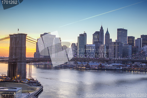 Image of Lights of New York City and Brooklyn Bridge at Sunset