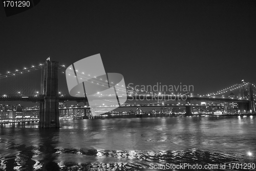 Image of Lights of New York City and Brooklyn Bridge at Sunset