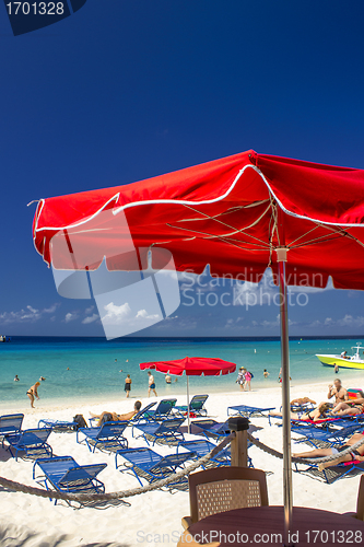 Image of Red Beach Umbrellas and turquoise Waters of Caribbean