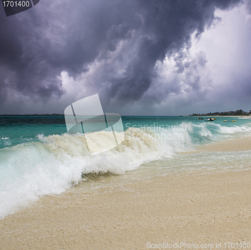 Image of Wave on the Beach with Storm in the Background