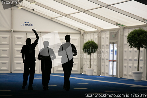 Image of silhouettes of people going