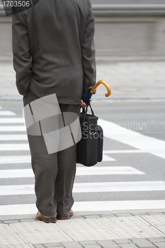 Image of buisiness man waiting at crosswalk