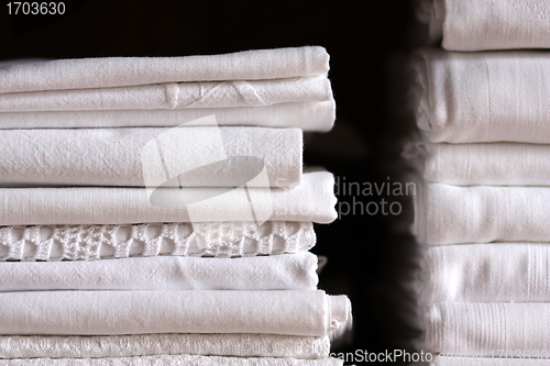 Image of Bed sheet pile and dark background