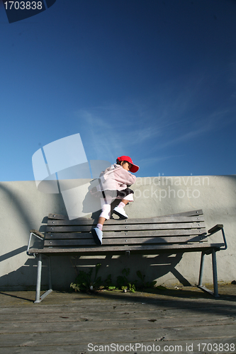 Image of child  climbing at a bench