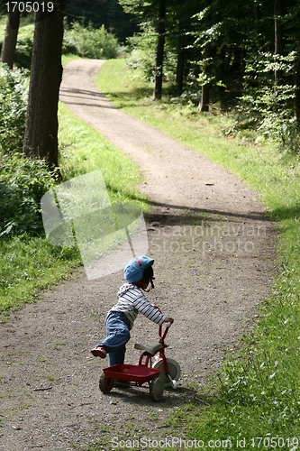 Image of child playing with her cycle