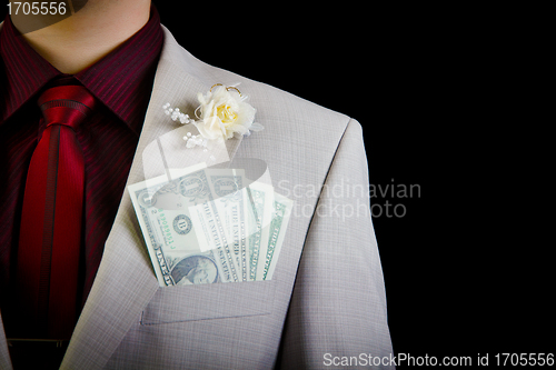 Image of dollars in the pocket of the groom's wedding suit