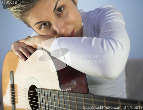 Image of woman and guitar