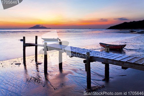 Image of Sunset coast at wooden pier